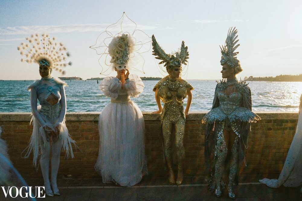 Models in Venice golden hour with a white vogue logo on the right bottom corner